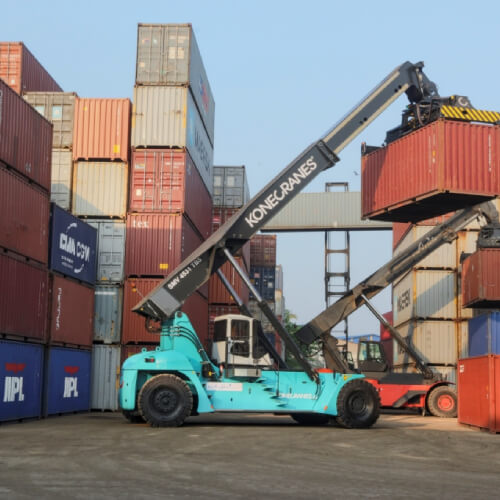 Container stacker cranes lifting up stacking container boxes in yard