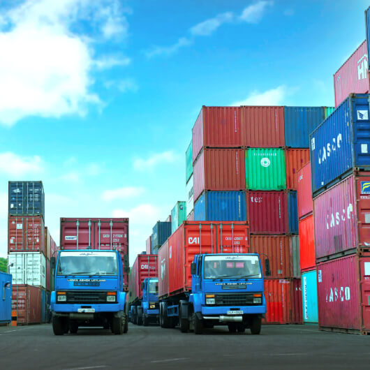 Trucks transporting container boxes in the yard